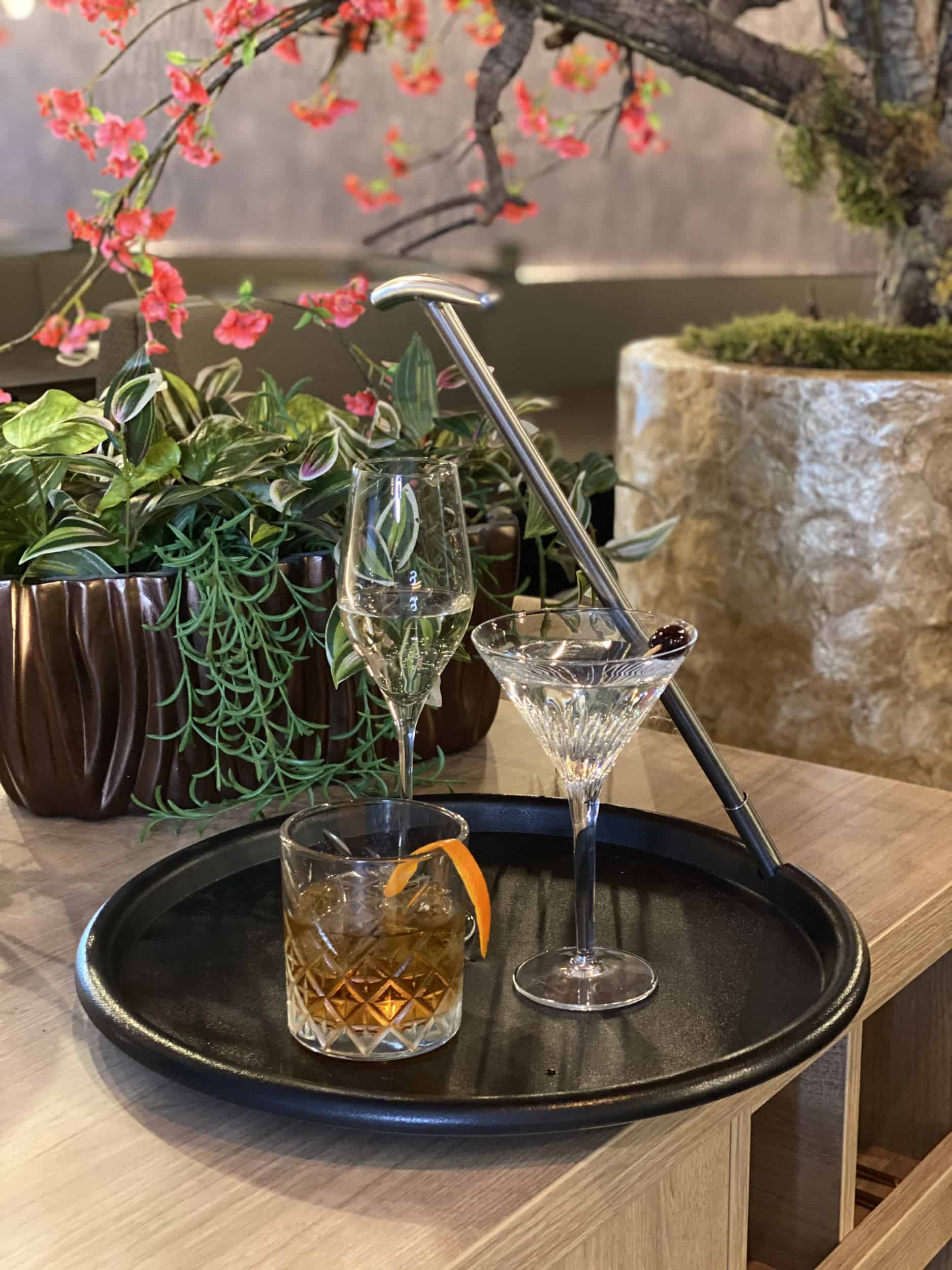 The Balance Tray with cocktails on a wooden counter