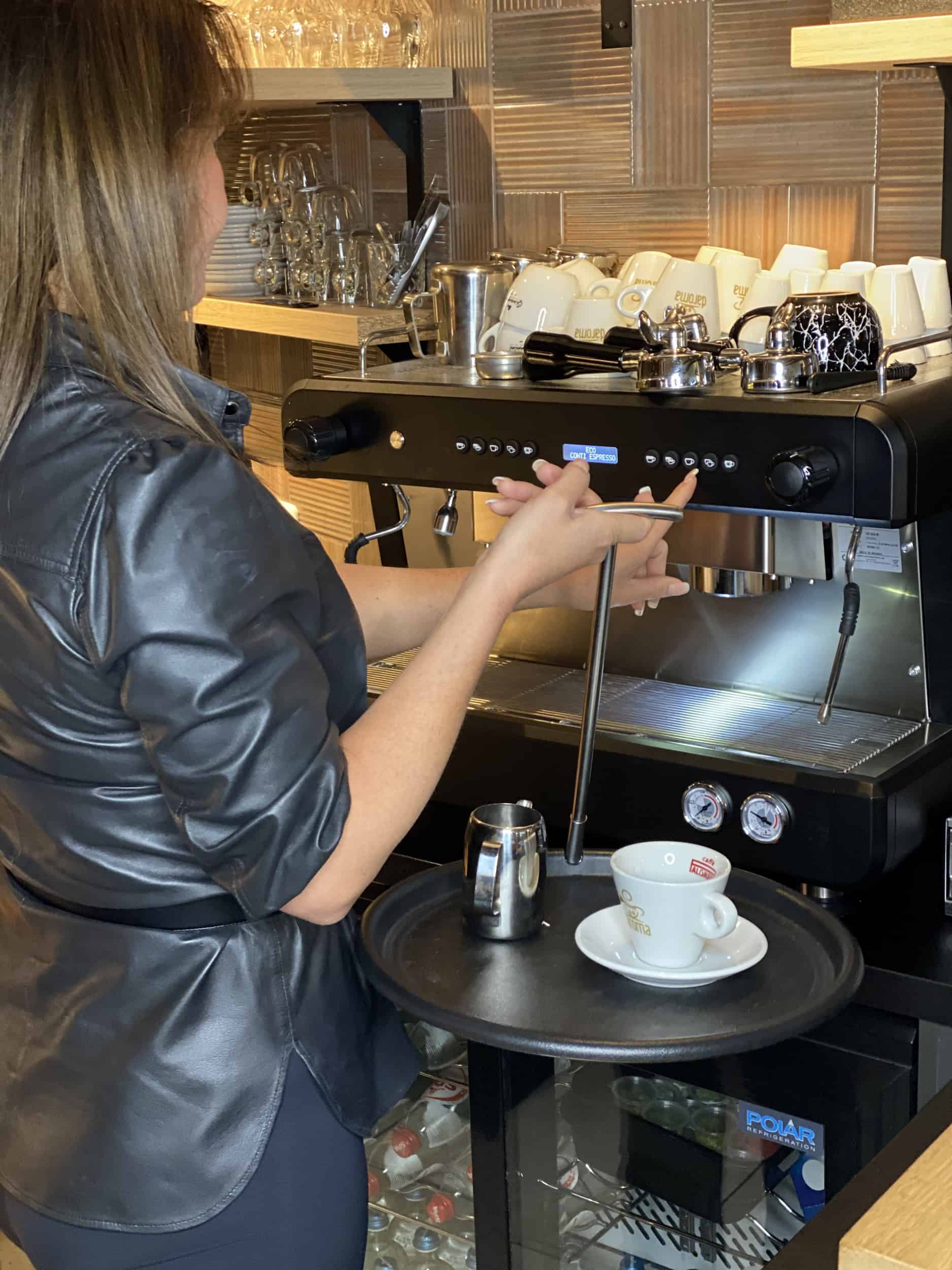 Holding the Balance Tray in one hand while working an espresso machine with the other