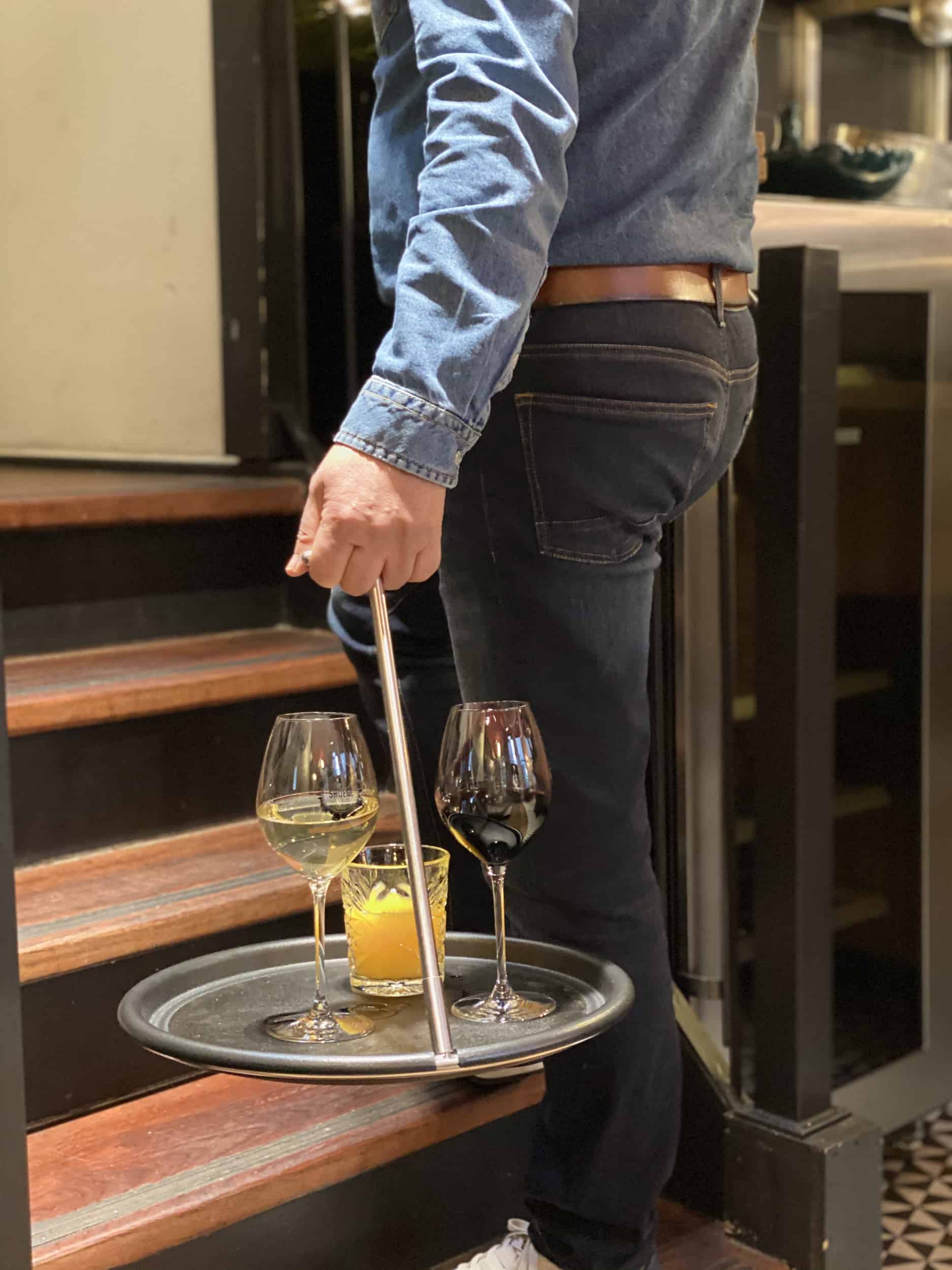Carrying wine glasses up a staircase on the Balance Tray