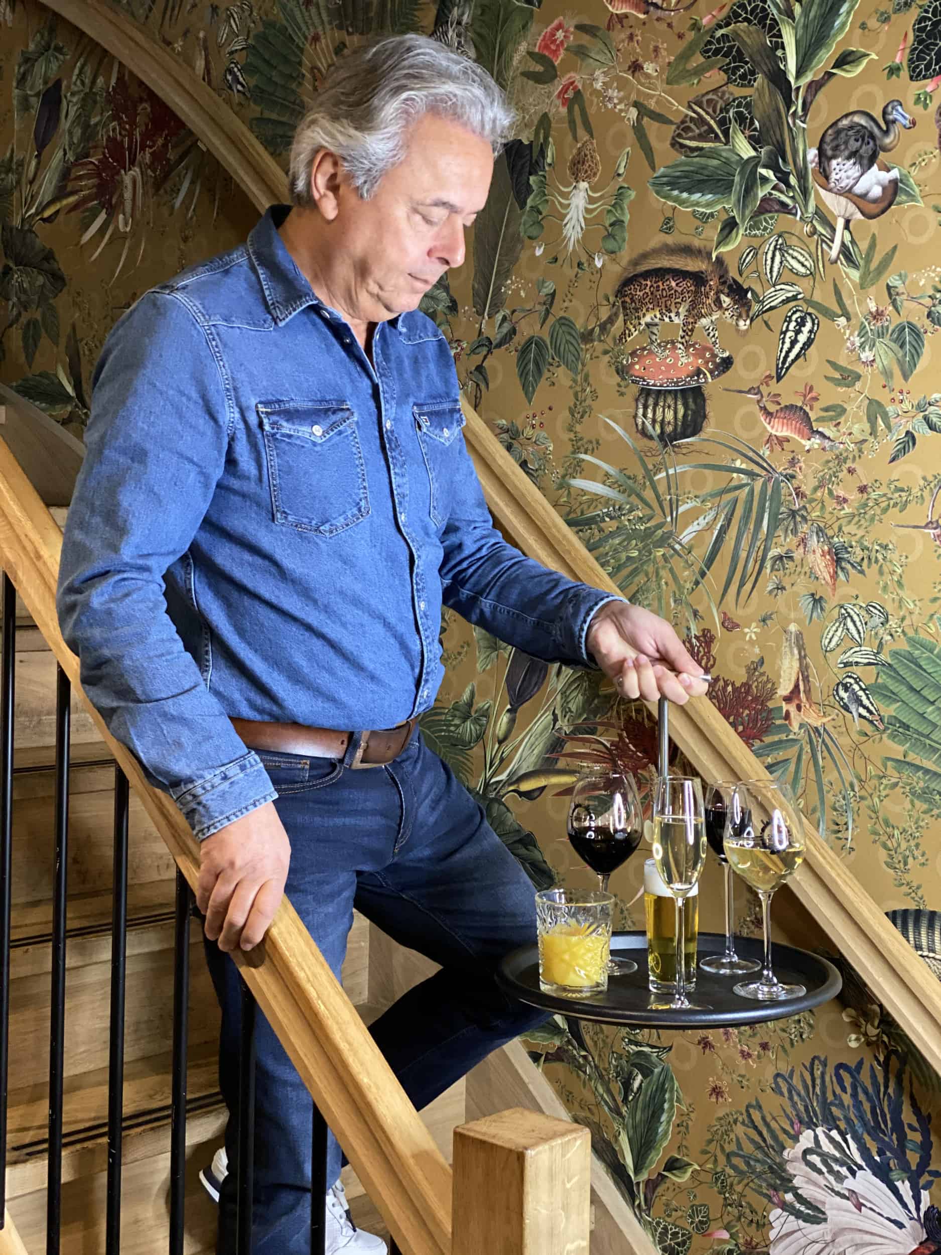 A man walking down the stairs with drinks on the Balance Tray